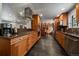 Open kitchen featuring stainless steel appliances, wooden cabinets, and tiled flooring at 13464 W Virginia Dr, Lakewood, CO 80228