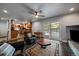 Living room with black tile floors and neutral walls leads to a chef's kitchen and outdoor pool at 13464 W Virginia Dr, Lakewood, CO 80228