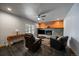Bright living room with a fireplace, wood paneling, and a sliding glass door to outside at 13464 W Virginia Dr, Lakewood, CO 80228