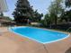 Backyard swimming pool, surrounded by concrete patio at 13464 W Virginia Dr, Lakewood, CO 80228