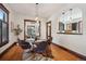 Elegant dining room with hardwood floors, a glass-top table, and views into the adjacent living room and kitchen at 2771 W 38Th Ave, Denver, CO 80211