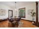 Bright dining room features hardwood floors, a glass table, and an open pass-through to the kitchen at 2771 W 38Th Ave, Denver, CO 80211