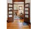 Living room with hardwood floors and fireplace, view through double doors at 2771 W 38Th Ave, Denver, CO 80211