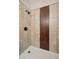 Clean shower with beige tile and wood-look accent at 2771 W 38Th Ave, Denver, CO 80211