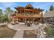 Rear view of home with covered deck, patio, and landscaped waterfall at 8090 S Homesteader Dr, Morrison, CO 80465