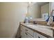 Bathroom vanity features a marble countertop, white cabinetry, and bronze fixtures at 8090 S Homesteader Dr, Morrison, CO 80465