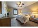 Bedroom with a neutral wall color, queen size bed, ceiling fan, and matching nightstands at 8090 S Homesteader Dr, Morrison, CO 80465