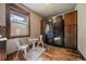 Cozy dining area features a wine cellar with wooden cabinets and black iron doors, adding charm and functionality at 8090 S Homesteader Dr, Morrison, CO 80465