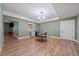 Spacious dining area with wood-look floors, a hanging chandelier, and a wet bar at 8090 S Homesteader Dr, Morrison, CO 80465