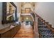 Grand foyer showcases a sweeping staircase with iron railings, hardwood floors, and soaring ceilings at 8090 S Homesteader Dr, Morrison, CO 80465