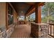 Charming front porch with swing and stone pillar base at 8090 S Homesteader Dr, Morrison, CO 80465