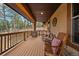 Cozy front porch with seating, rocking chairs, and wood railing at 8090 S Homesteader Dr, Morrison, CO 80465