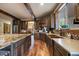 Open concept kitchen showcasing dark wood cabinetry, granite countertops, and wood floors at 8090 S Homesteader Dr, Morrison, CO 80465