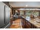 Modern kitchen boasting stainless steel appliances and a large island with barstool seating at 8090 S Homesteader Dr, Morrison, CO 80465