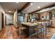 Spacious kitchen features an island with seating and granite countertops, wood floors, and beamed ceiling at 8090 S Homesteader Dr, Morrison, CO 80465