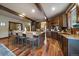 Modern kitchen boasting an island with barstool seating, granite countertops, and dark wood cabinets at 8090 S Homesteader Dr, Morrison, CO 80465