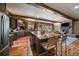 Spacious kitchen featuring a large island with barstool seating and an open dining area at 8090 S Homesteader Dr, Morrison, CO 80465
