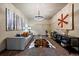 Bright living room features a modern chandelier, stylish decor, and comfortable seating at 8090 S Homesteader Dr, Morrison, CO 80465