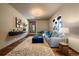 Stylish living room with plush seating, modern decor, neutral tones, and hardwood flooring with unique rug at 8090 S Homesteader Dr, Morrison, CO 80465