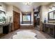 Luxurious main bathroom features a soaking tub, separate shower, dual vanities, and elegant fixtures for pampering at 8090 S Homesteader Dr, Morrison, CO 80465