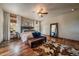 Bright bedroom boasts hardwood floors, ceiling fan, natural light, and stylish decor for a serene retreat at 8090 S Homesteader Dr, Morrison, CO 80465