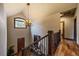 Elegant staircase with wood floors, wrought iron railings, and a chandelier at 8090 S Homesteader Dr, Morrison, CO 80465