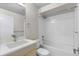 Full bathroom with shower and tub, featuring modern fixtures and bright white tiling at 3875 E 4Th Ave # 2, Denver, CO 80206