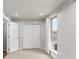 Well-lit bedroom featuring double closets, carpet, and a bright window at 3875 E 4Th Ave # 2, Denver, CO 80206