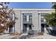 Attractive modern townhomes featuring gray brick facade and stylish entryways with landscaping at 3875 E 4Th Ave # 2, Denver, CO 80206