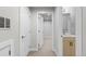 Hallway with a view of a half bathroom with modern fixtures and light wood vanity at 3875 E 4Th Ave # 2, Denver, CO 80206