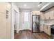 Spacious kitchen featuring stainless steel refrigerator and modern light wood cabinetry at 3875 E 4Th Ave # 2, Denver, CO 80206