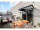 Inviting outdoor patio with comfortable seating and wooden table under black sunshades at 3875 E 4Th Ave # 2, Denver, CO 80206