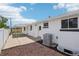 Exterior view of a home with a white brick exterior and a well-maintained backyard at 6068 Lee St, Arvada, CO 80004