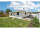 Spacious backyard featuring a lush lawn, white fence, and covered patio area at 6068 Lee St, Arvada, CO 80004
