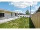A lush backyard with a well-manicured lawn, white fence, and the home's exterior at 6068 Lee St, Arvada, CO 80004