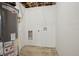 Unfinished basement area showcasing a water heater and utility hookups at 6068 Lee St, Arvada, CO 80004