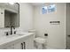Modern bathroom with black fixtures, herringbone vanity, and updated shower at 6068 Lee St, Arvada, CO 80004