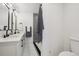 Bathroom featuring double sinks, black faucets, large mirrors, and updated shower at 6068 Lee St, Arvada, CO 80004