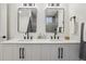 Modern bathroom with double sinks, sleek black fixtures, and stylish herringbone vanity at 6068 Lee St, Arvada, CO 80004