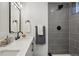 Contemporary bathroom boasting a stylish gray tile shower and a floating vanity at 6068 Lee St, Arvada, CO 80004