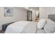 Relaxing bedroom showcasing a queen bed and access to an adjacent bathroom at 6068 Lee St, Arvada, CO 80004
