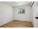 Neutral bedroom with one window, hardwood floors and a closet at 6068 Lee St, Arvada, CO 80004