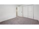 Spacious carpeted bedroom featuring a large closet with white doors at 6068 Lee St, Arvada, CO 80004