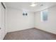 Bright bedroom with a large window, closet, and carpet flooring at 6068 Lee St, Arvada, CO 80004