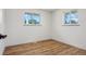 Neutral bedroom with 2 windows and hardwood floors at 6068 Lee St, Arvada, CO 80004
