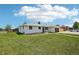Charming home featuring a lush green lawn and a freshly painted white exterior at 6068 Lee St, Arvada, CO 80004