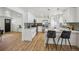 Modern kitchen featuring stainless steel appliances, sleek cabinetry, and an eat-in island at 6068 Lee St, Arvada, CO 80004