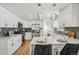 Bright kitchen with white cabinets, stainless steel appliances, and stylish pendant lighting at 6068 Lee St, Arvada, CO 80004
