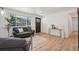 Inviting living room featuring hardwood floors, a large window, and a stylish couch at 6068 Lee St, Arvada, CO 80004