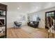 A bright and modern living room with new flooring, fresh paint and updated lighting at 6068 Lee St, Arvada, CO 80004